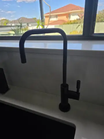 Black filtered drinking water tap at the kitchen sink