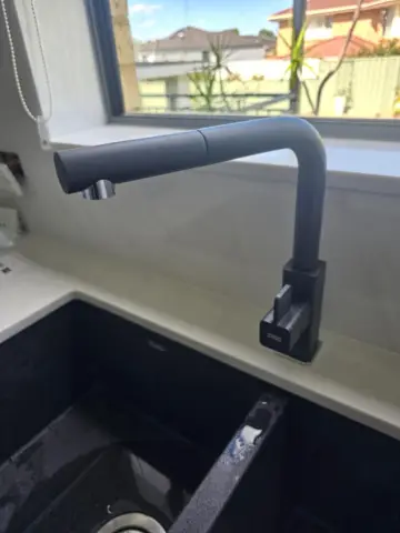 Black pull-out kitchen mixer tap fitted by our plumber