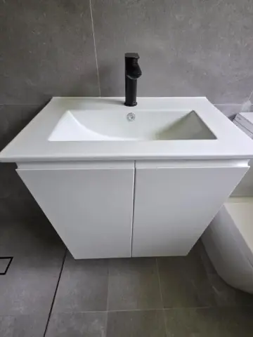 Compact white vanity with black basin mixer