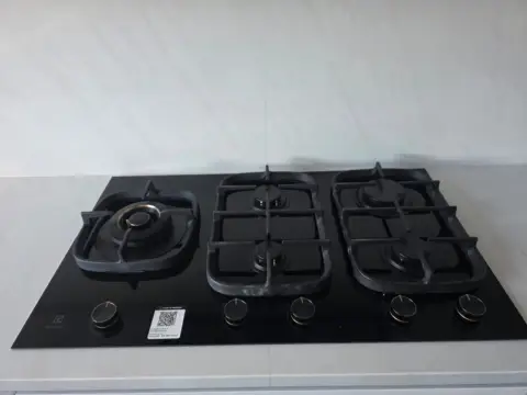 Five-burner gas cooktop installed and connected by a licensed gas fitter