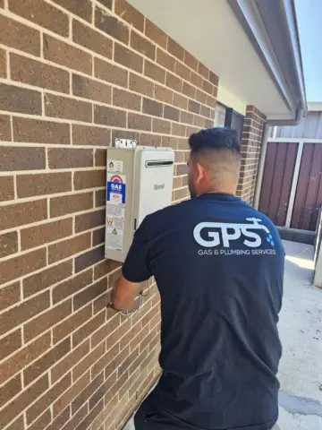 GPS plumber installing a continuous-flow gas hot water system