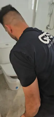 GPS plumber installing a new toilet