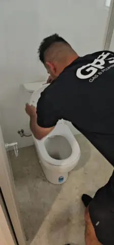 Licensed plumber fitting a toilet pan