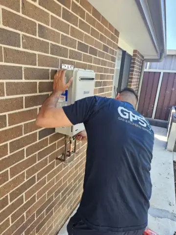 Plumber connecting an instantaneous gas hot water unit