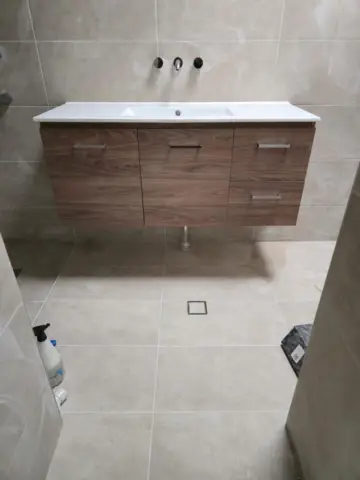 Timber-look vanity with wall mixer