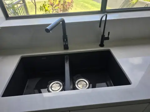 Black undermount double sink with filtered water tap