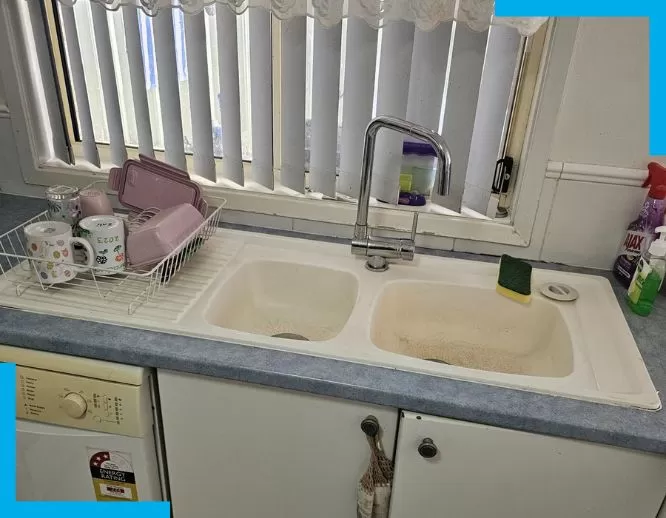 Sydney plumber performing routine maintenance check on residential pipes.